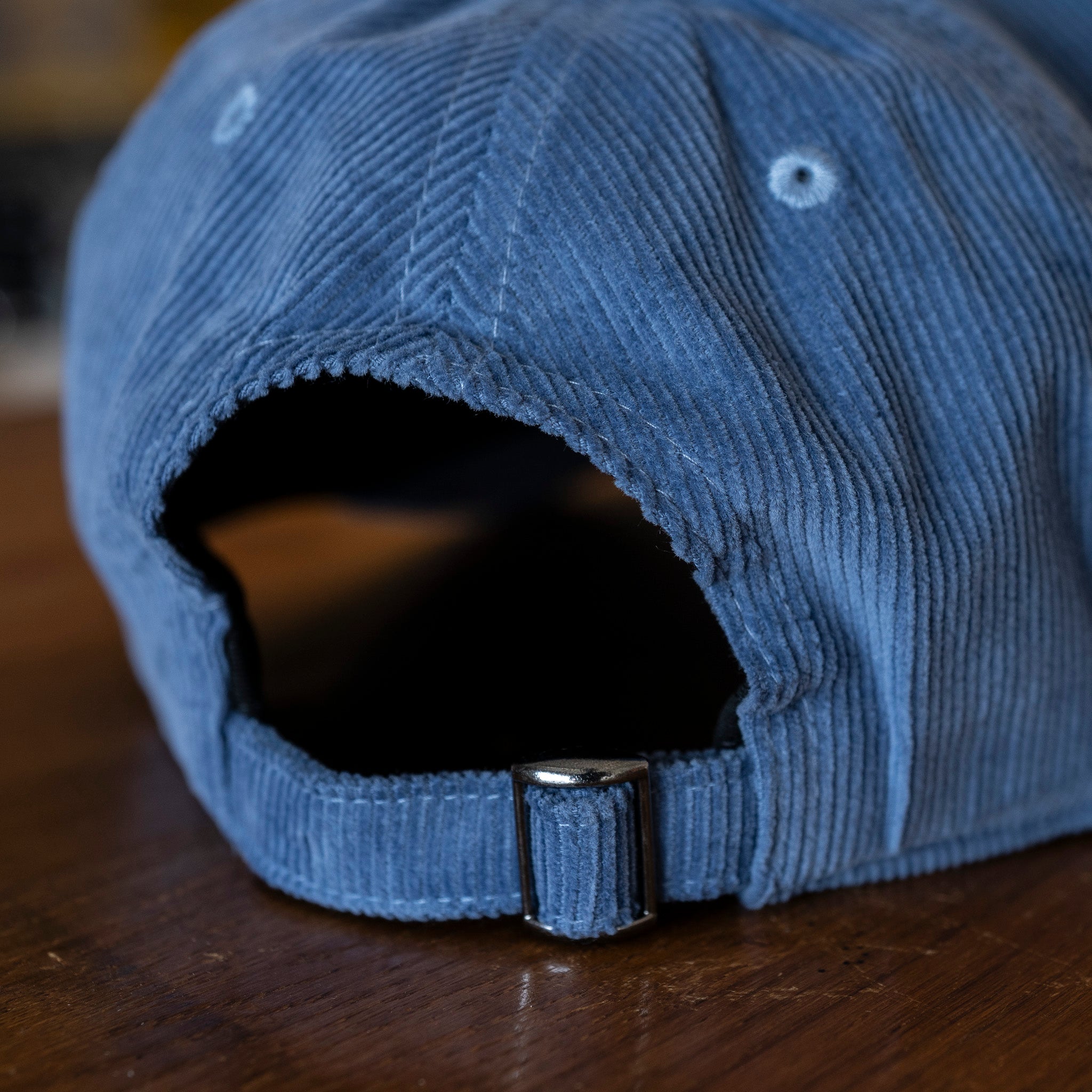 Close up of adjustment strap of Slate Blue corduroy baseball cap