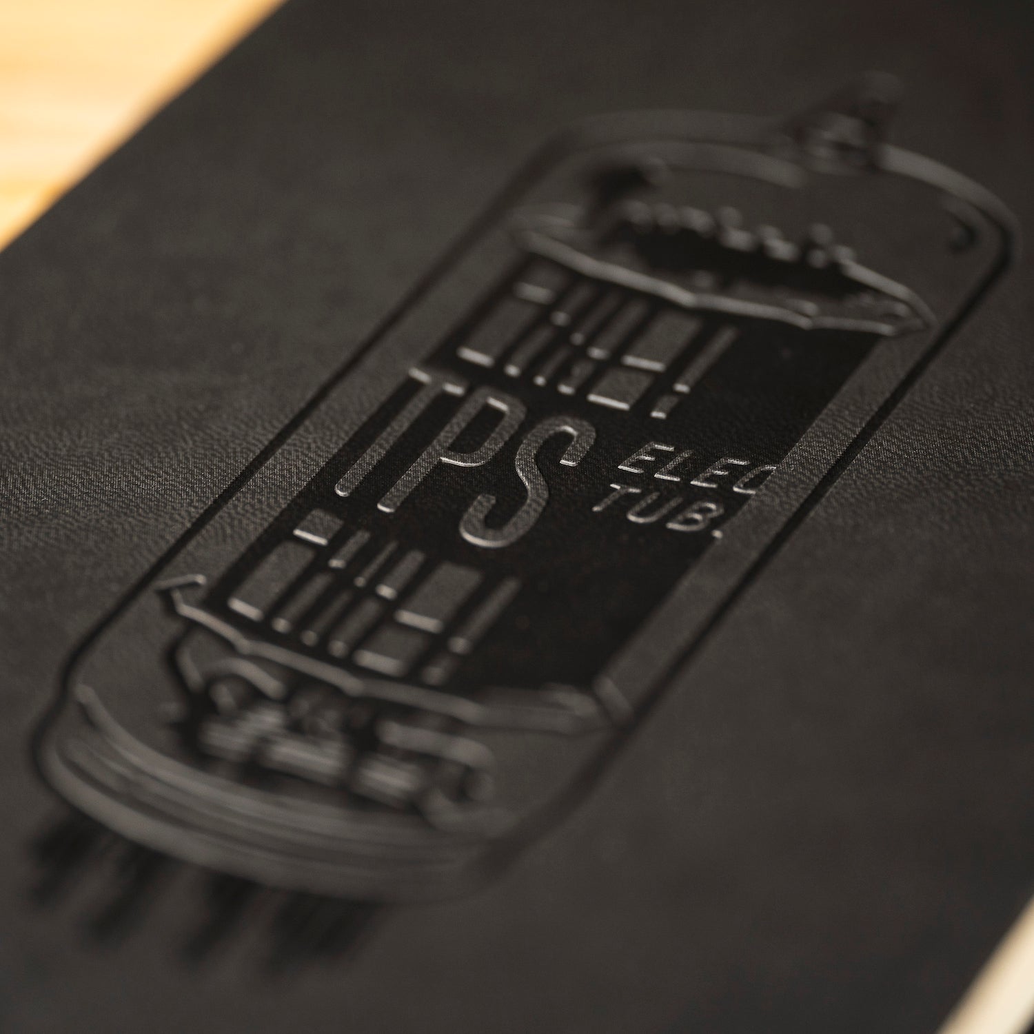 Close up of deboss design on cover of That Pedal Show notebook