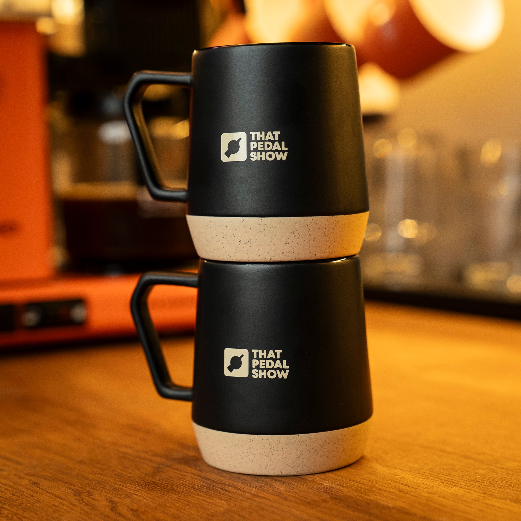 Two stacked That Pedal Show Dipped Glaze Mugs