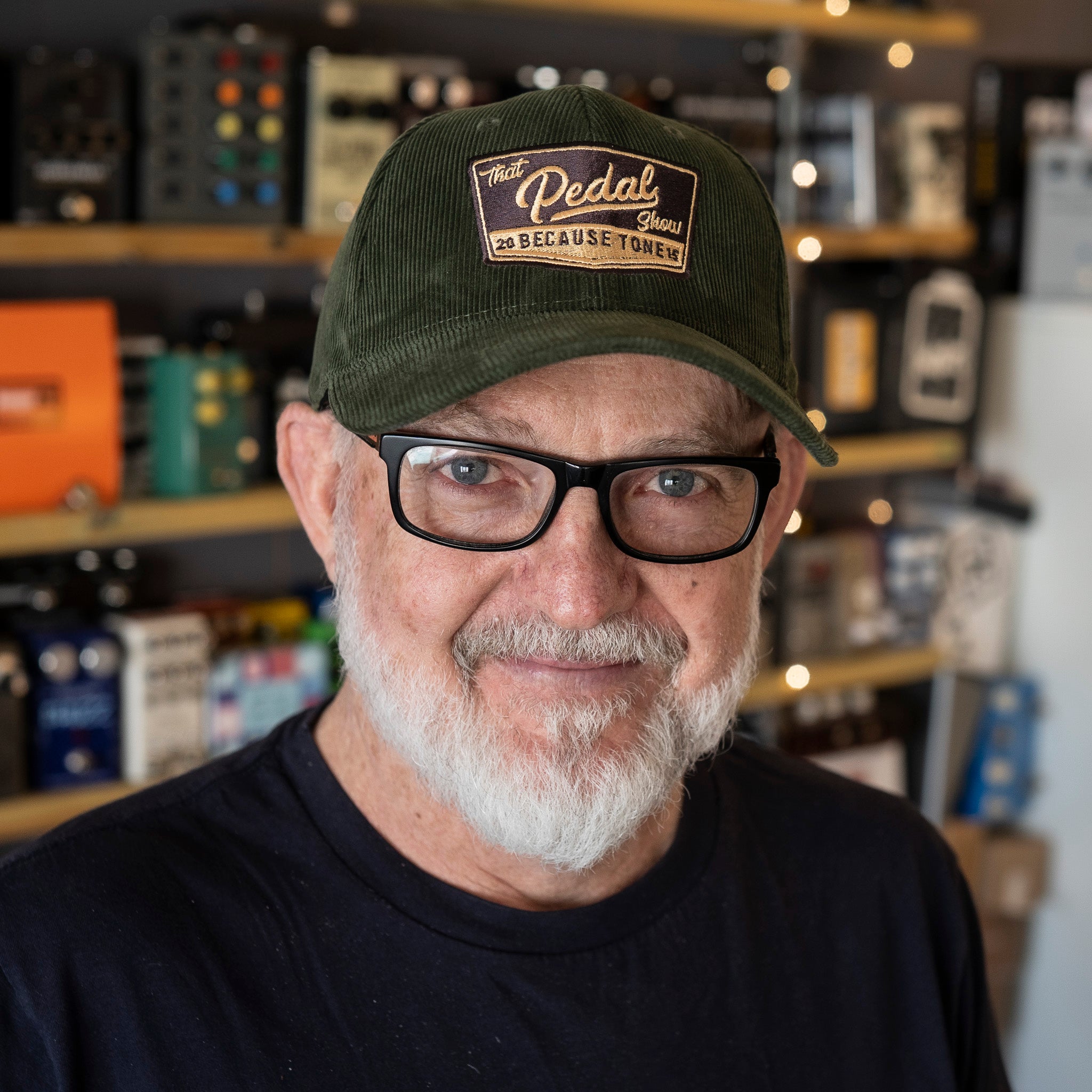 Dan wears Forest Green corduroy baseball cap with vintage That Pedal Show logo embroidered onto front.