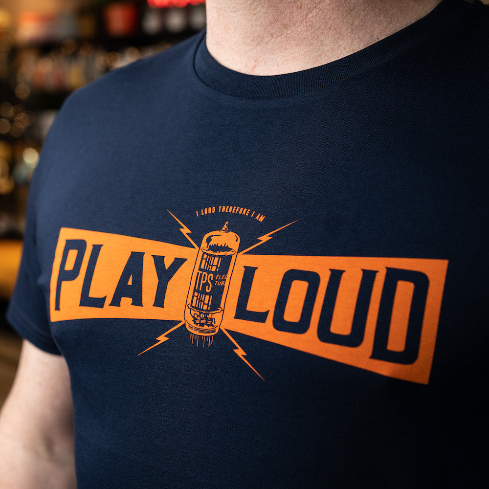 Close up of the TPS Play Loud design on a navy blue t-shirt