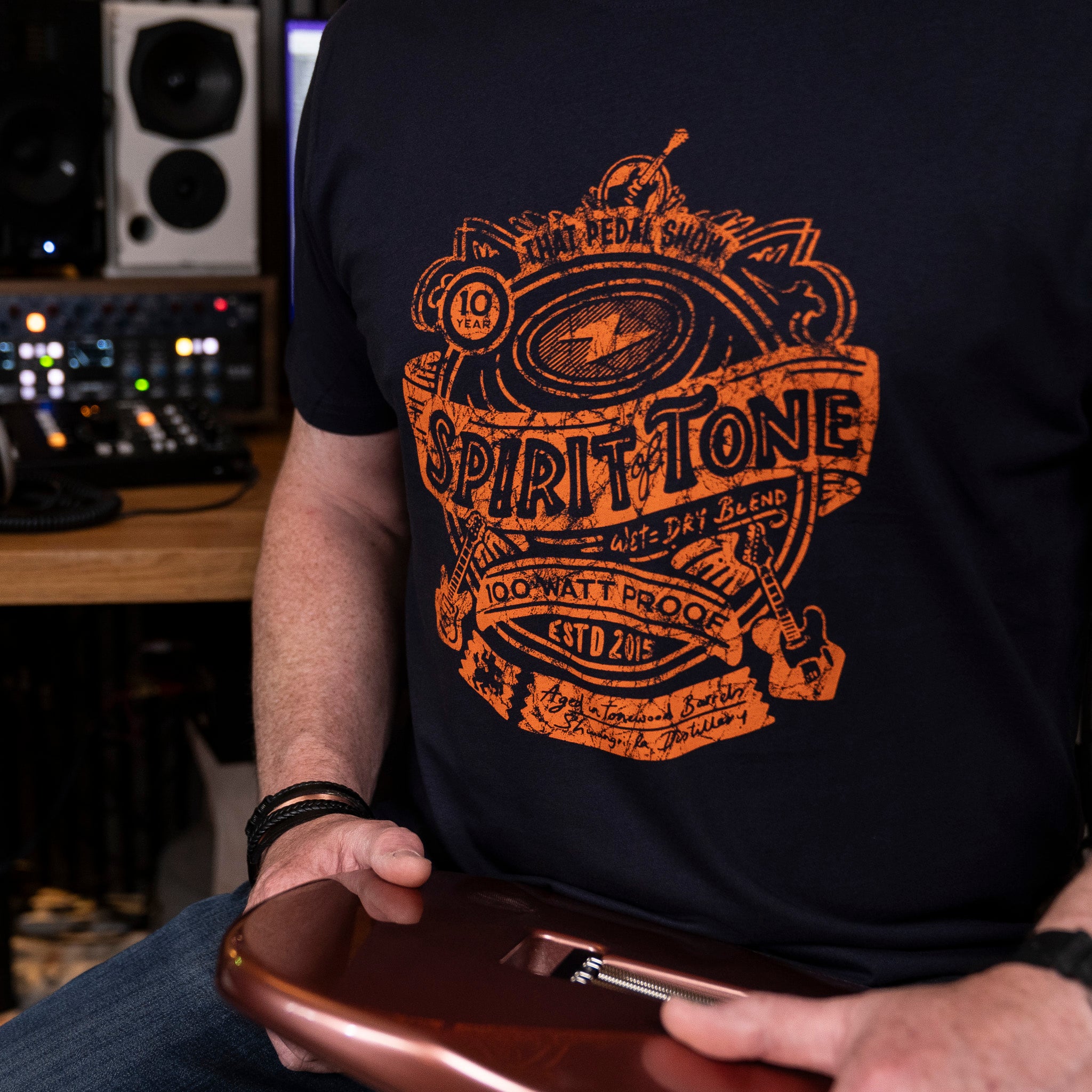 Close up of a Navy t-shirt with the 'Spirit of Tone' design in orange on the chest.