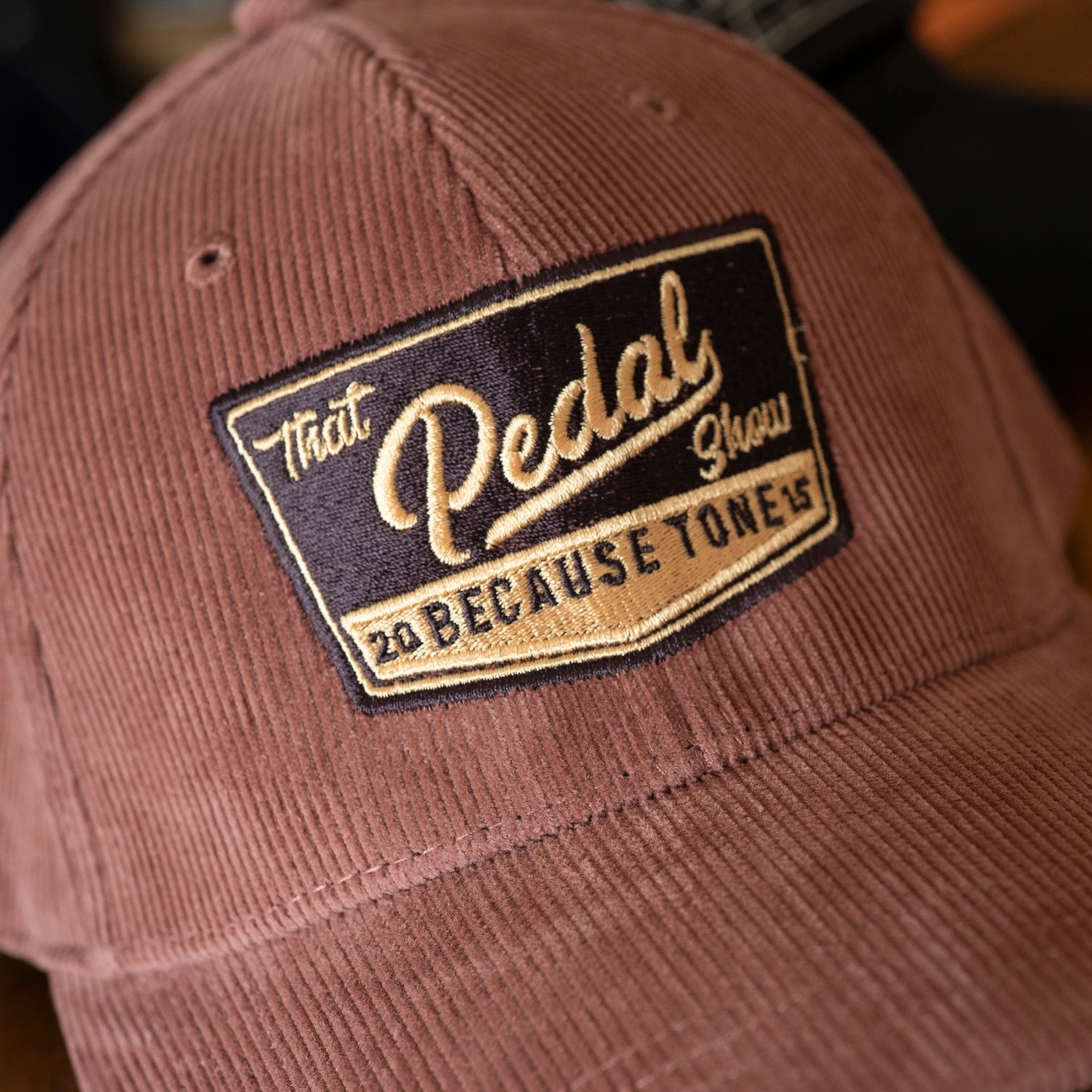 Cord baseball cap from That Pedal Show, close up of embroidered logo
