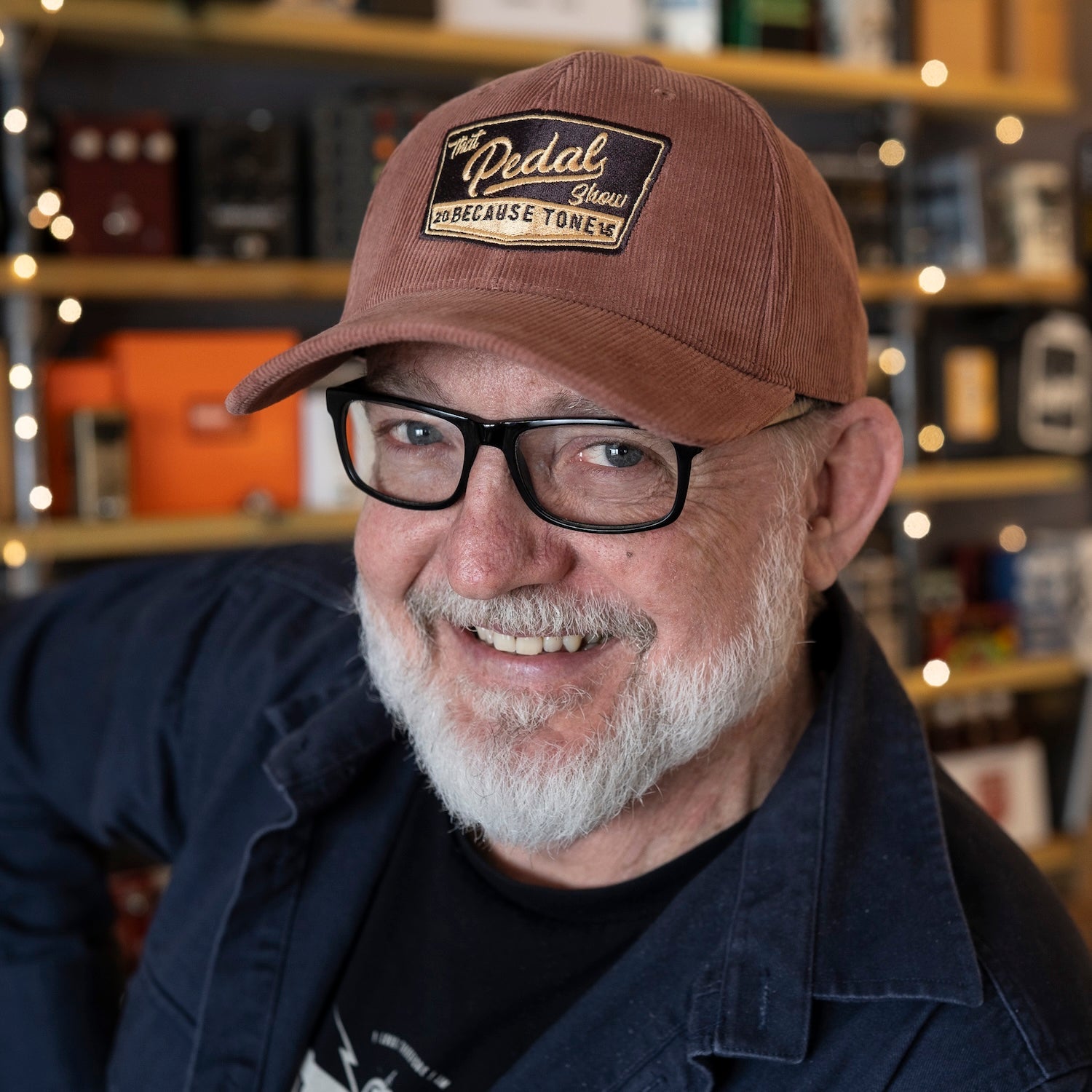 Dan wears corduroy baseball cap with vintage That Pedal Show logo embroidered onto front.
