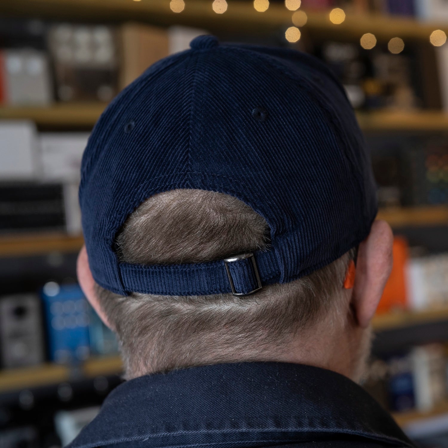 Back view of a TPS cord baseball cap showing the size adjustment strap